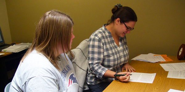 Writing Center Assistant providing student with writing instruction