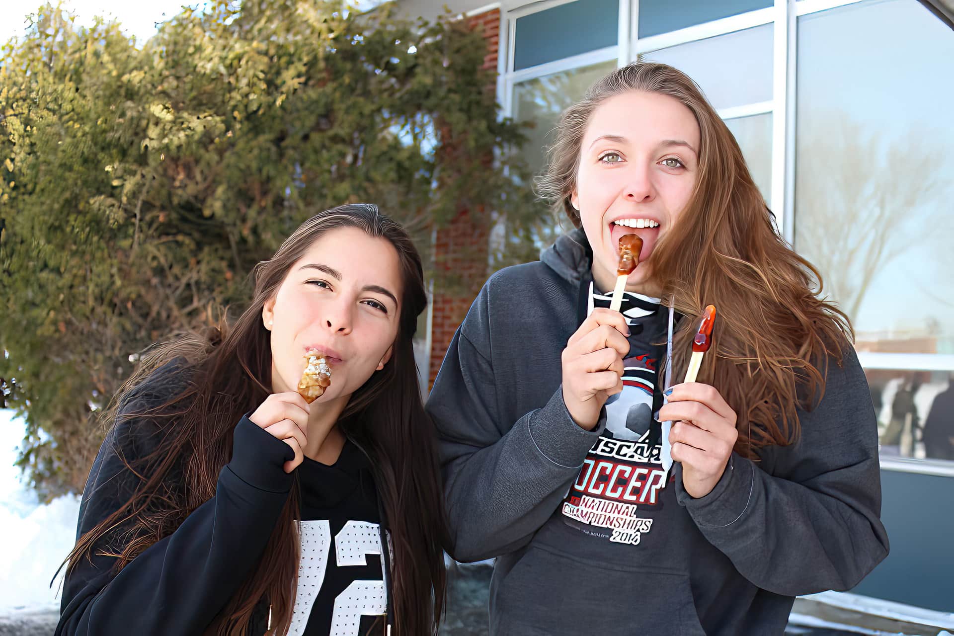 UMFK College Students enjoying the Sucrerie and maple taffy on the snow