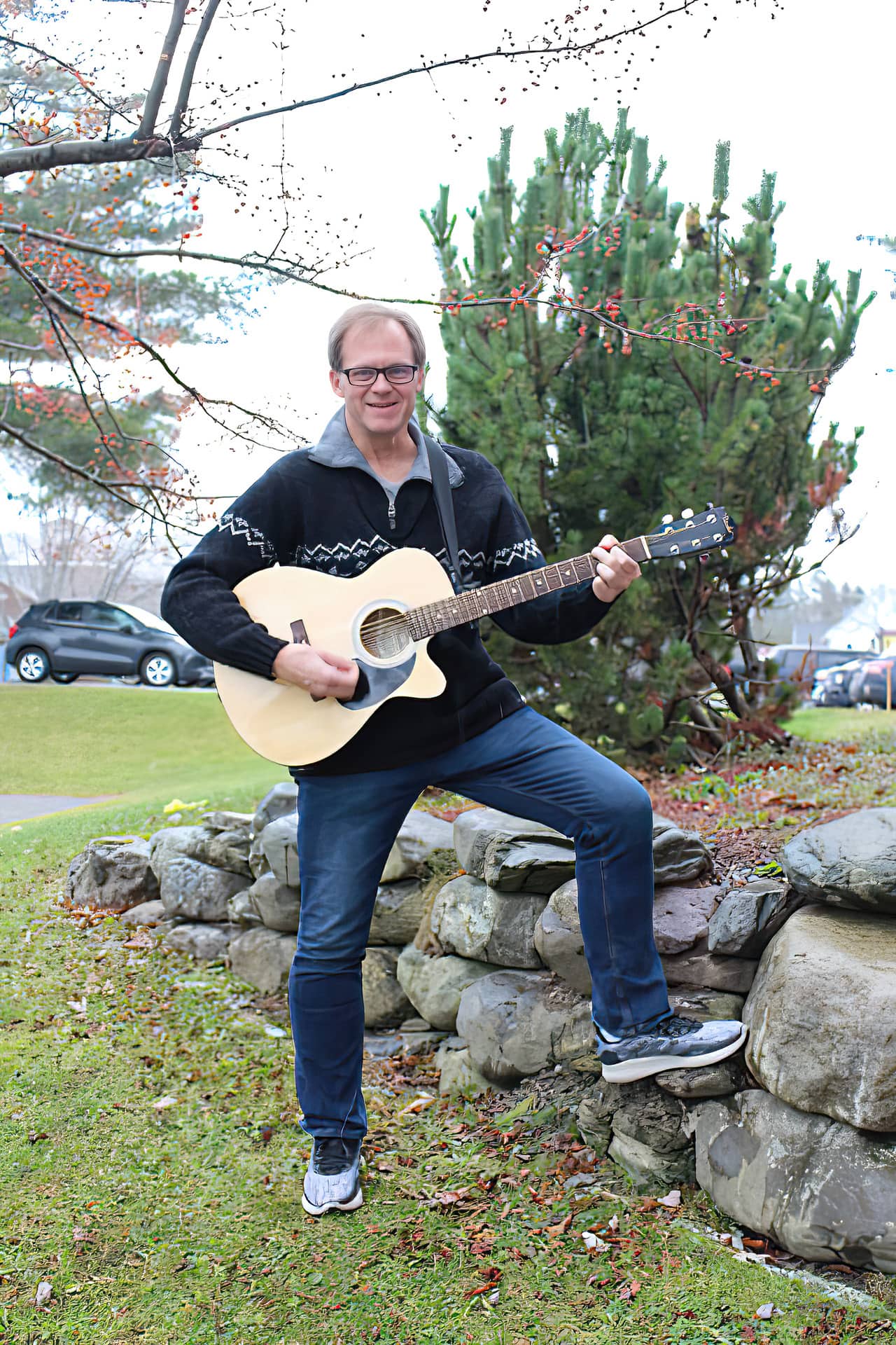 Dr. Scott Brickman with guitar photo outside of OMS