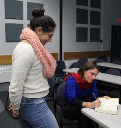 Following the pubic reading, UMFK student Adriana Gutierrez has writer Sarah Creech sign her copy of "Season of the Dragonflies."