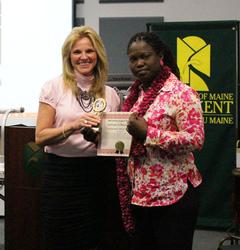 UMFK Student Support Services Director Lena Michaud presents trophy and certificate to UMFK nursing student Mary Trudeau