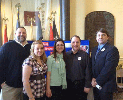 Shawn Graham, Kaprice Tompkins, Ivon Portellez, Alan Pelletier, and state Senator Troy Jackson pose for a photo at the state capitol