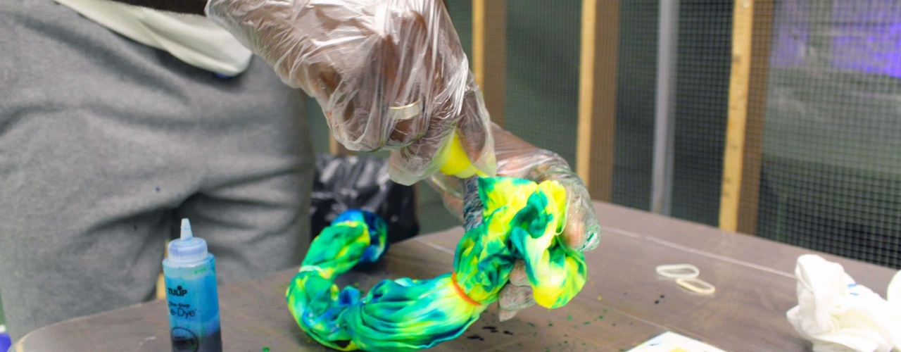 a student makes a tie-dyed shirt