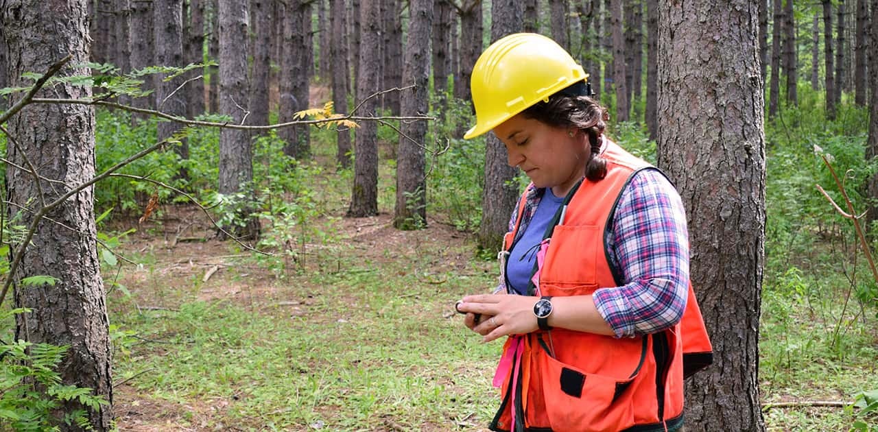 UMFK forestry professor uses a compass to find her way