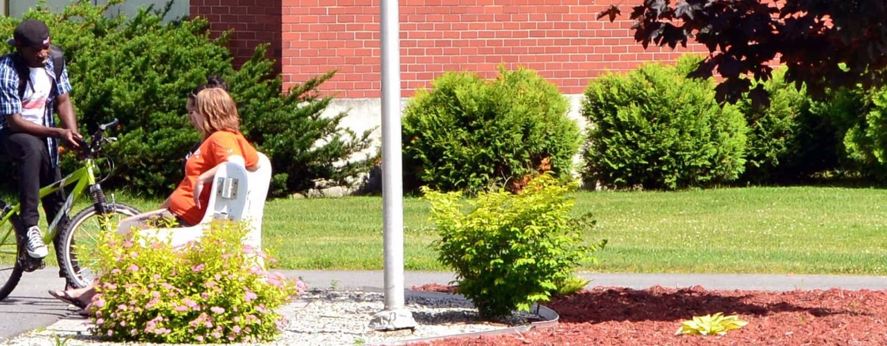 Two students meeting near Cyr Hall