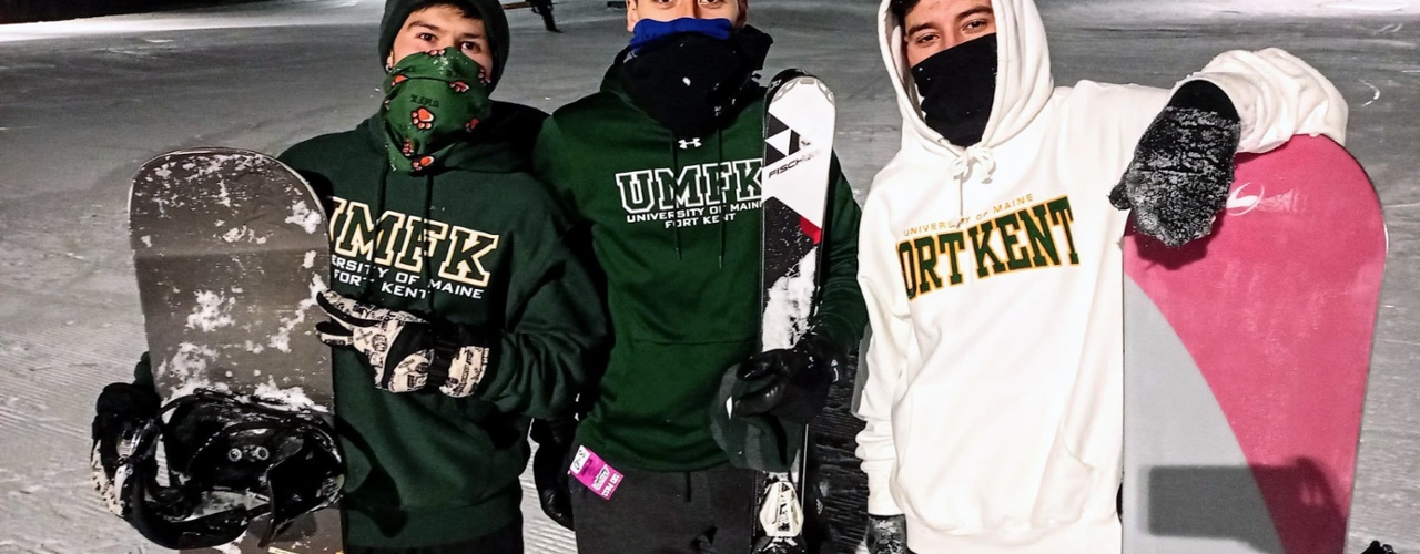 a group of students pose for the camera after snowboarding down the local ski hill during a ski night