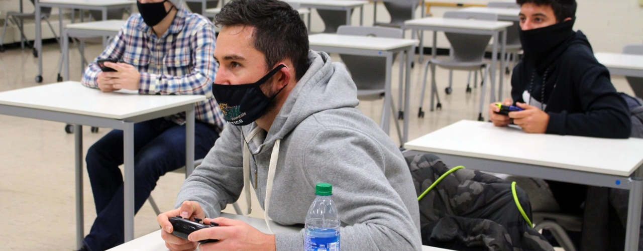 Students play video games in Nadeau hall conference room