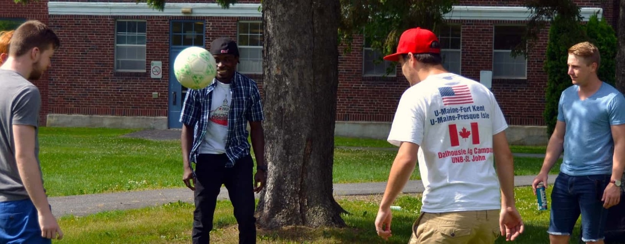 Students passing around a soccer ball on the quad