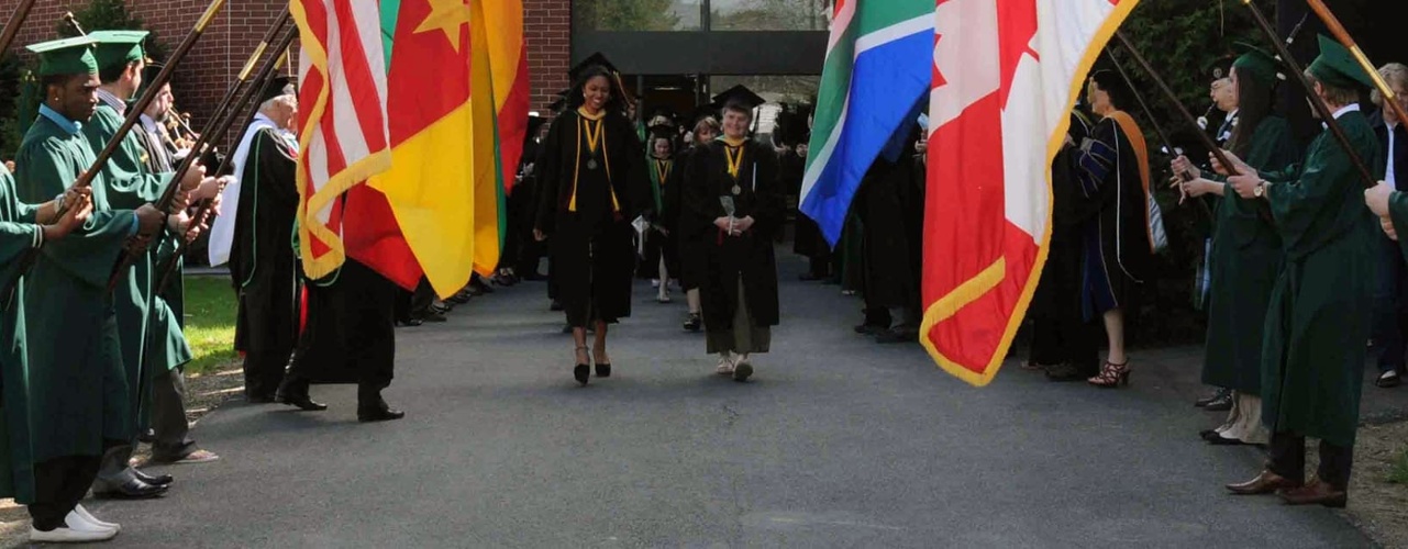 Graduates Walking Out Through the Flags