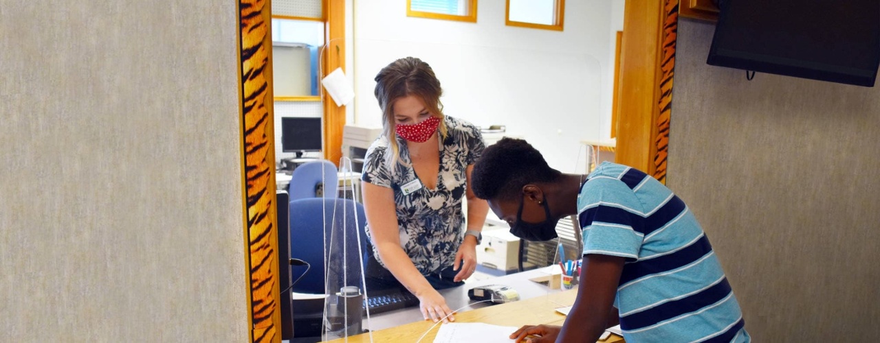 UMFK Bursar assists a student with paperwork