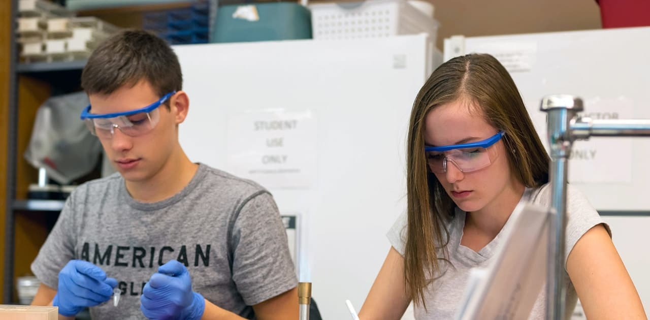 two students working in a biology lab on the UMFK campus