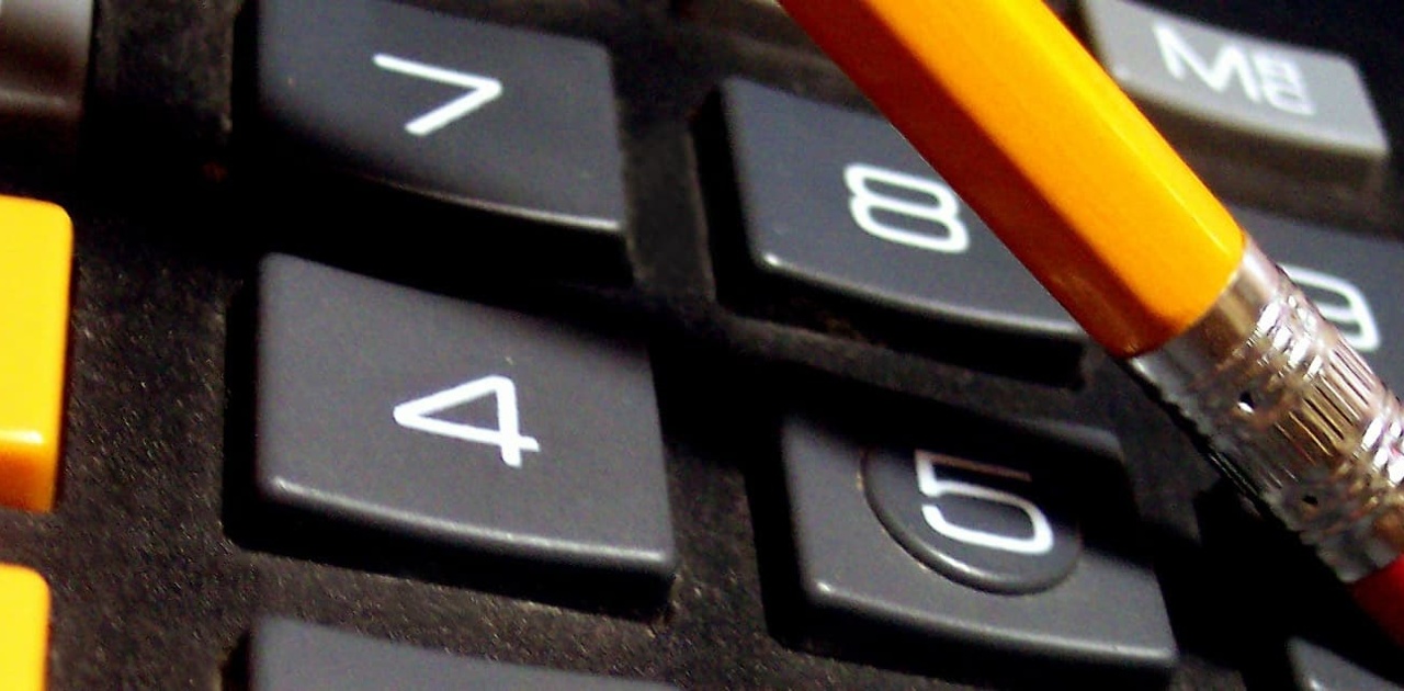 a closeup of a calculator and pencil